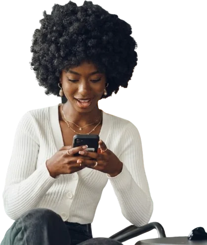 Woman smiling as she uses a smartphone